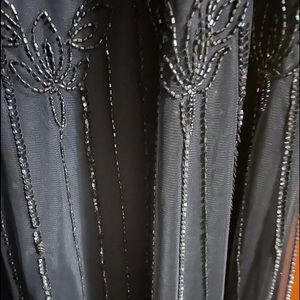 Beautiful dark blue gown worn once. Excellent shape. Not missing any beads. Firm